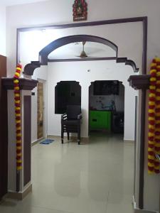 a living room with an archway and a television at Saimithra Riverview Homestay in Tirunelveli +16 photos