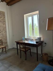 a room with a wooden table and a window at Fattoria solidale del Circeo in Pontinia