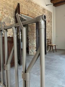 a row of metal bars in front of a brick wall at Fattoria solidale del Circeo in Pontinia