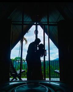 two people are standing in a room with a camera at Nine Mist Heaven in Ella