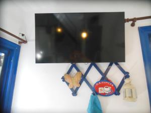 a tv hanging on the side of a wall at Nagos Home in Nagós +9 photos