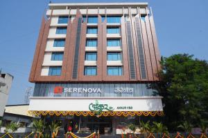 a tall building with a sign in front of it at Hotel Serenova, Pune- Pure Veg in Pune