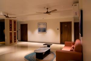 a living room with a couch and a table at Hotel Serenova, Pune- Pure Veg in Pune