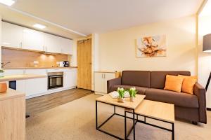 a living room with a couch and a table at Hotel Garni WEISSES LAMM in Erlangen