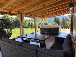 a screened in patio with a pool table and a table at Villa Ema in Pale