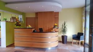 a lobby with a reception desk in a building at Hotel Garni WEISSES LAMM in Erlangen