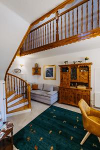 a living room with a staircase and a couch at Ferienwohnungen Proschahaus in Eisenberg an der Pinka +28 photos