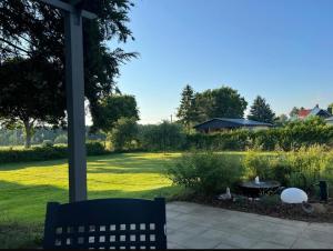 a bench sitting under a gazebo in a yard at Haus Charenza in Garz