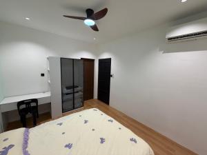 a bedroom with a bed and a ceiling fan at Permai Lake Residence in Sibu