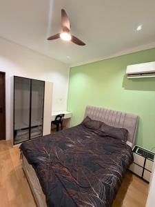 a bedroom with a bed and a ceiling fan at Permai Lake Residence in Sibu