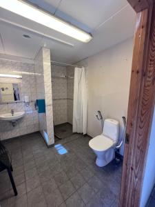 a bathroom with a toilet and a sink at Raet Camping in Færvik +30 photos
