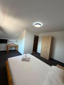 a bedroom with a bed with towels on it at Casa Aylin in Corbu +10 photos