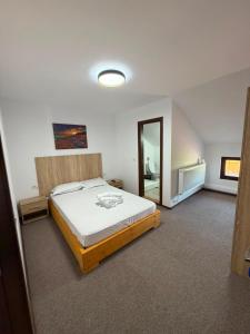 a bedroom with a large bed and a mirror at Casa Aylin in Corbu