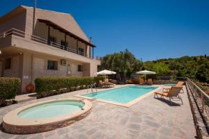 a swimming pool in front of a house at Villa Maragoudi in Arménoi