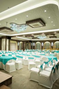 a banquet hall with blue and white tables and chairs at Hotel Serenova, Pune- Pure Veg in Pune