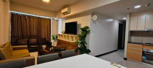 a kitchen and a living room with a couch and a table at Mactan Newtown Condo Rentals in Punta Engaño