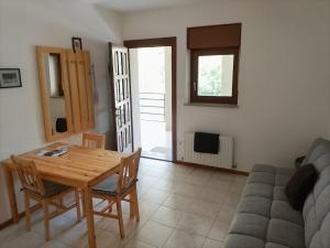 a living room with a table and a couch at Soča Trails Apartment #4 in Srpenica