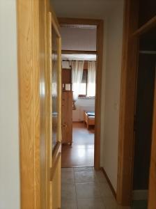 a hallway with a door open to a room at Soča Trails Apartment #4 in Srpenica +3 photos
