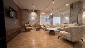 a waiting room with a couch and chairs and a table at Settle inn Jebal apartments in Cairo