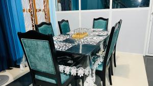 a black and white dining room with a table and chairs at RL Holiday Inn in Jaffna