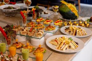 a table topped with plates of food and drinks at Settle inn Jebal apartments in Cairo