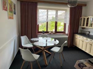 a kitchen with a table and chairs and a window at Apartmán PASOMA in Levoča