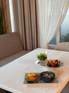 a table with two plates of food on it at Harmonie Radauti in Rădăuţi