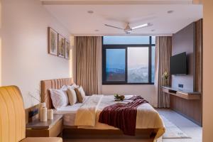 a bedroom with a bed and a large window at Hotel Serenova, Pune- Pure Veg in Pune +73 photos