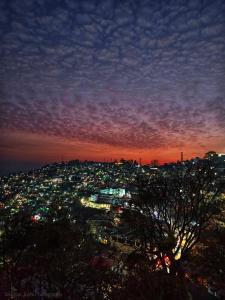 a view of a city lit up at night at Hotel Almora Palace in Almora