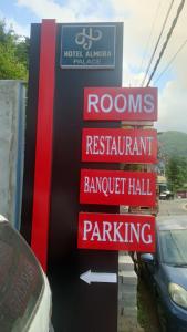 a sign for a roms restaurant and parking at Hotel Almora Palace in Almora
