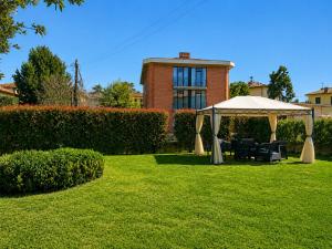 a gazebo with chairs under it in a yard at Villa Catelli in Lucca
