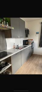 a kitchen with white cabinets and a sink at Haus Lisa in Kroisbach