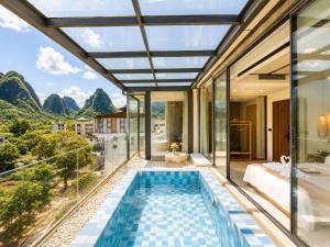 a villa with a swimming pool and a view at Yulong River Scenic Area,Floor-to-ceiling Windows for viewing,Swimming Pool & Coffee & Butler Service,10 minutes by car from West Street in Yangshuo