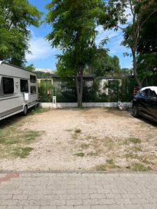 an rv parked in a yard next to a tree at Camp Mali Baška in Baška +5 photos