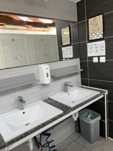 a bathroom with two sinks and a mirror at Camp Mali Baška in Baška