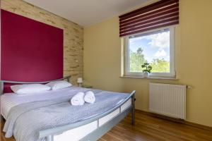 a bedroom with a bed with towels on it at Willa Beskidek PLUS in Szczyrk