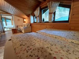 a bedroom with two beds in a room with windows at Rauchenberg Apartments in Lofer