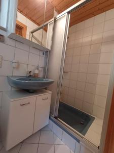 a bathroom with a sink and a shower at Rauchenberg Apartments in Lofer +19 photos
