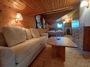 a living room with a couch and a table at Rauchenberg Apartments in Lofer