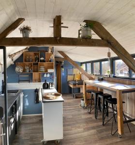 a kitchen with a long table and some chairs at Le Loft de l'auberge du Lac Noir in Saint-Cernin-de-Larche