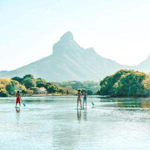 a group of people standing on a body of water at Sweet Beach Bungalow in Tamarin +31 photos