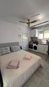 a bedroom with a large bed with two towels on it at Sadova Messinia Pearl Cozy Seafront House in Avía +21 photos