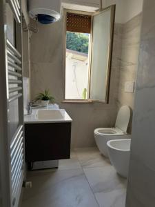 a bathroom with a sink and a toilet and a window at La casetta sul mare in Ortona +26 photos