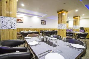 a dining room with tables and chairs in a restaurant at AYUSHKAMA COTTAGE #Naddi Sunset Point#Free Parking#cricket stadium8 km#Mcleodganj 2 km- Bhagsunag 4 km in Dharamshala