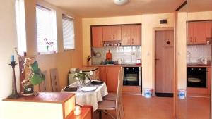 a kitchen with a table and a kitchen with a table and chairs at Harmony in Sveti Vlas