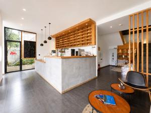 a kitchen with a counter and some chairs and tables at Yulong River Scenic Area,Floor-to-ceiling Windows for viewing,Swimming Pool & Coffee & Butler Service,10 minutes by car from West Street in Yangshuo