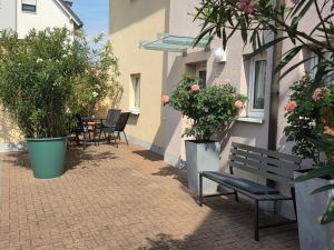 a bench sitting next to a building with plants at Ferienhaus Maria in Breitengüßbach