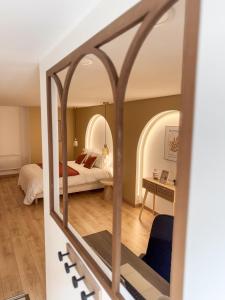 a bedroom with a bed and a mirror at Les arches in Riom +15 photos