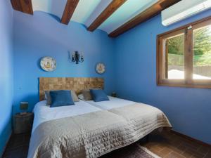 a blue bedroom with a bed and a window at Finca Fuente Laurel in Arucas +37 photos