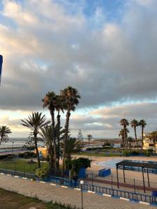 a view of a park with palm trees at Piscine, plage et relaxation in Pont Blondin